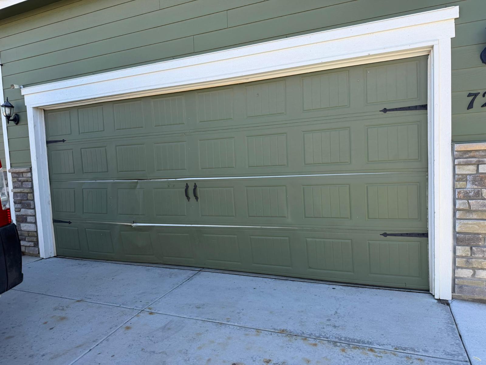 Garage door in Frederick, CO bent and knocked off-track after a driveway accident